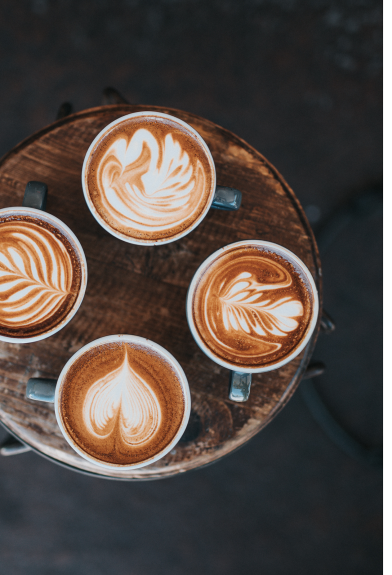 Four cups showing coffee art